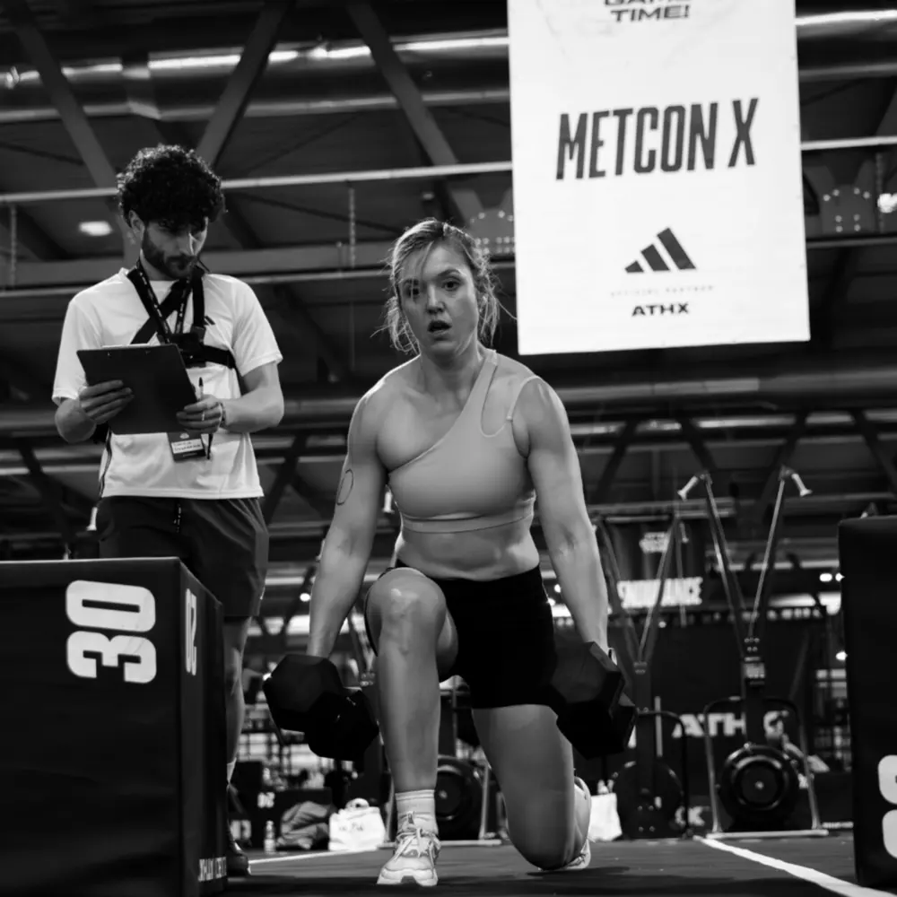 An ATHX athlete in the MetCon X zone with dumbbells.